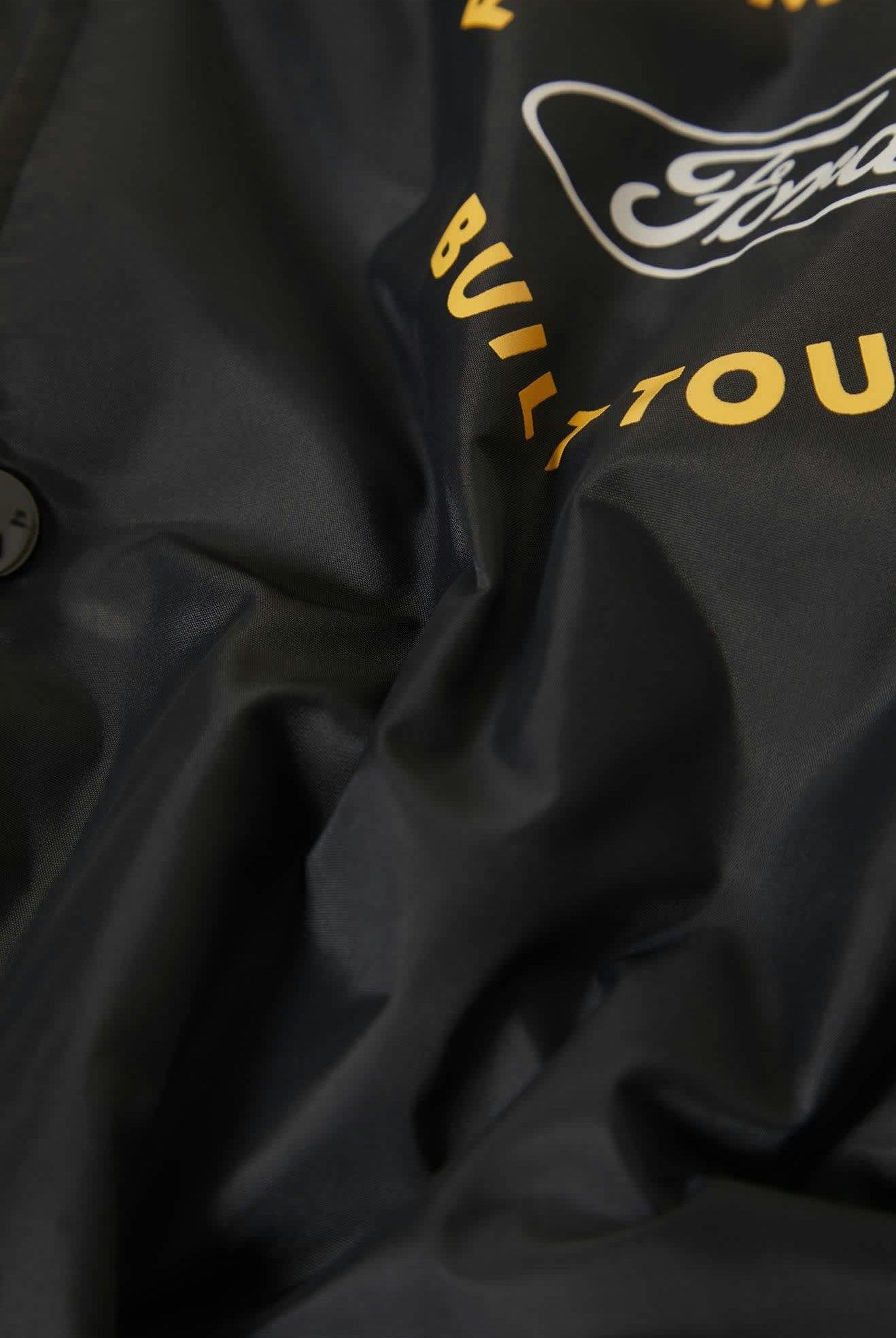 Men's Ford Built Tough Windbreaker in the color Burnt Rubber - Additional Laydown image