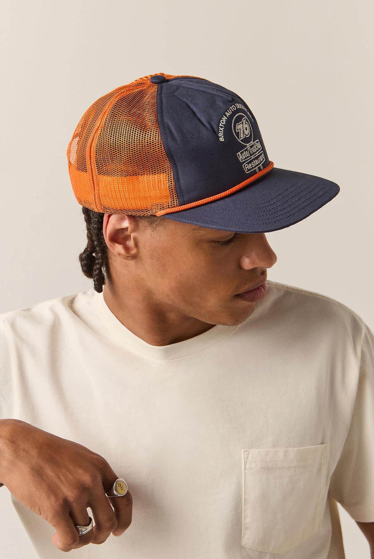 Unisex 76 Truck Stop Trucker Hat in the color Navy/Orange - Men's Side View