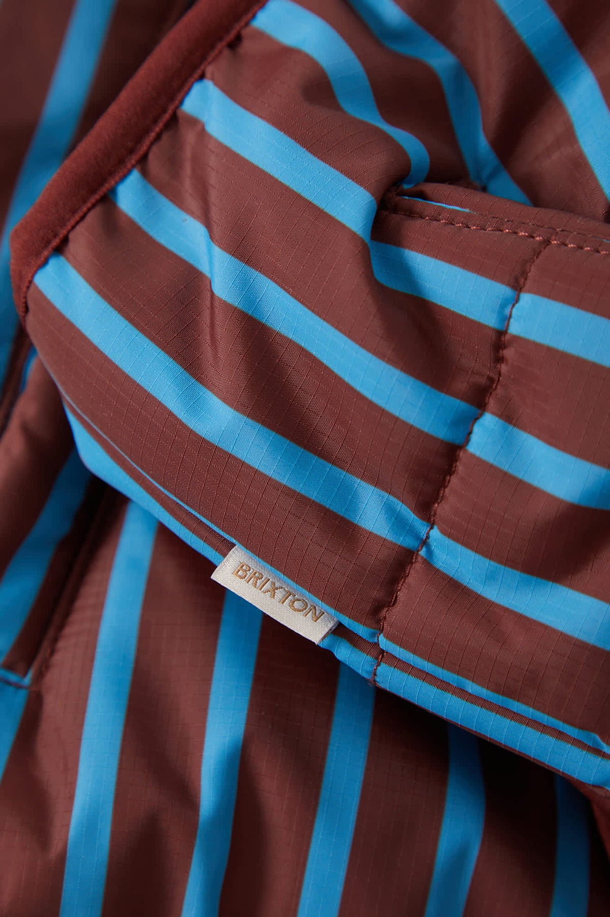 Women's Delilah Mock Neck Jacket in the color Dark Brick/Electric Indigo Stripe - Additional Laydown image
