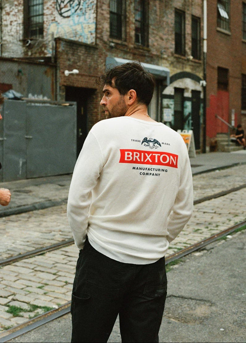 Man wearing a Brixton thermal on a street with urban background