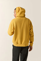 Men's Brixton Baseline Hood Fleece in the color Dusted Ochre Vintage Wash - Men's Back View